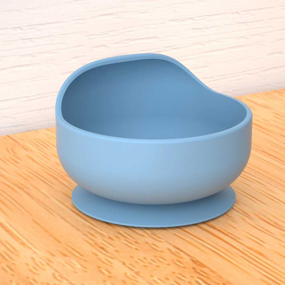 Blue suction cup bowl on a wooden surface