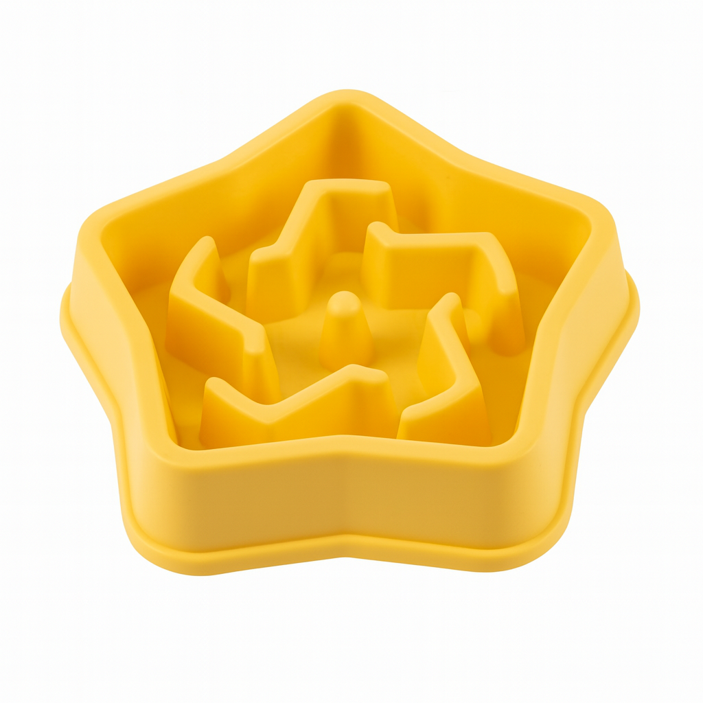 Yellow silicone slow feeder with a star-shaped cavity on a white background