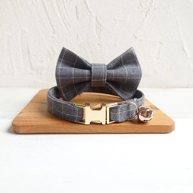 Grey Plaid dog bow tie and collar set on a wooden board with a white background