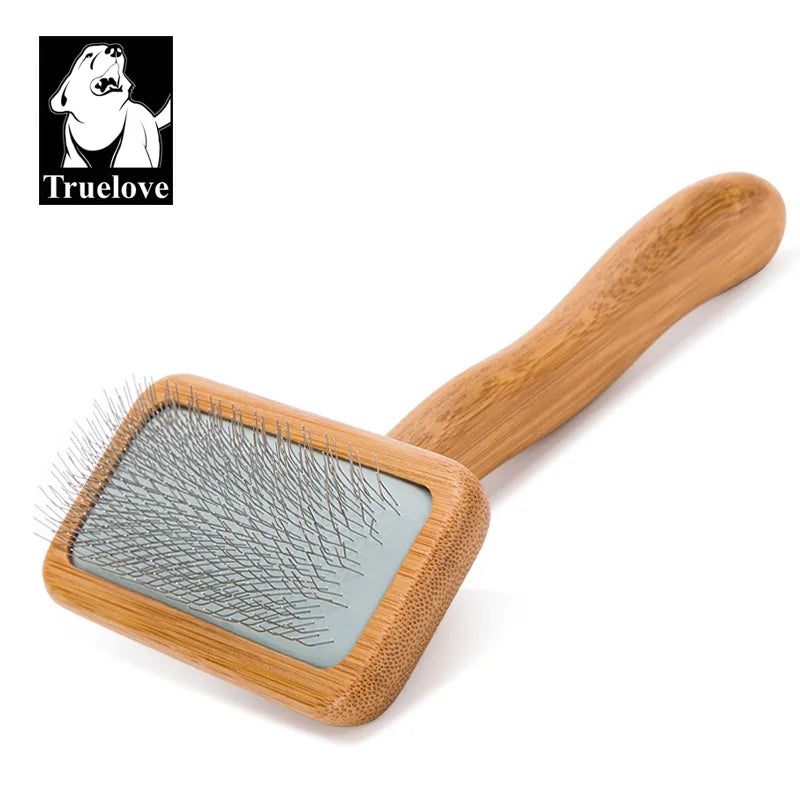Pet grooming brush with wooden handle and metal bristles on a white background