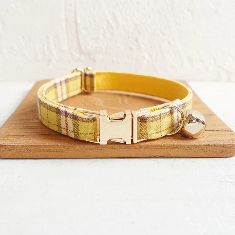 Yellow plaid dog collar with stainless steel buckle and bell.