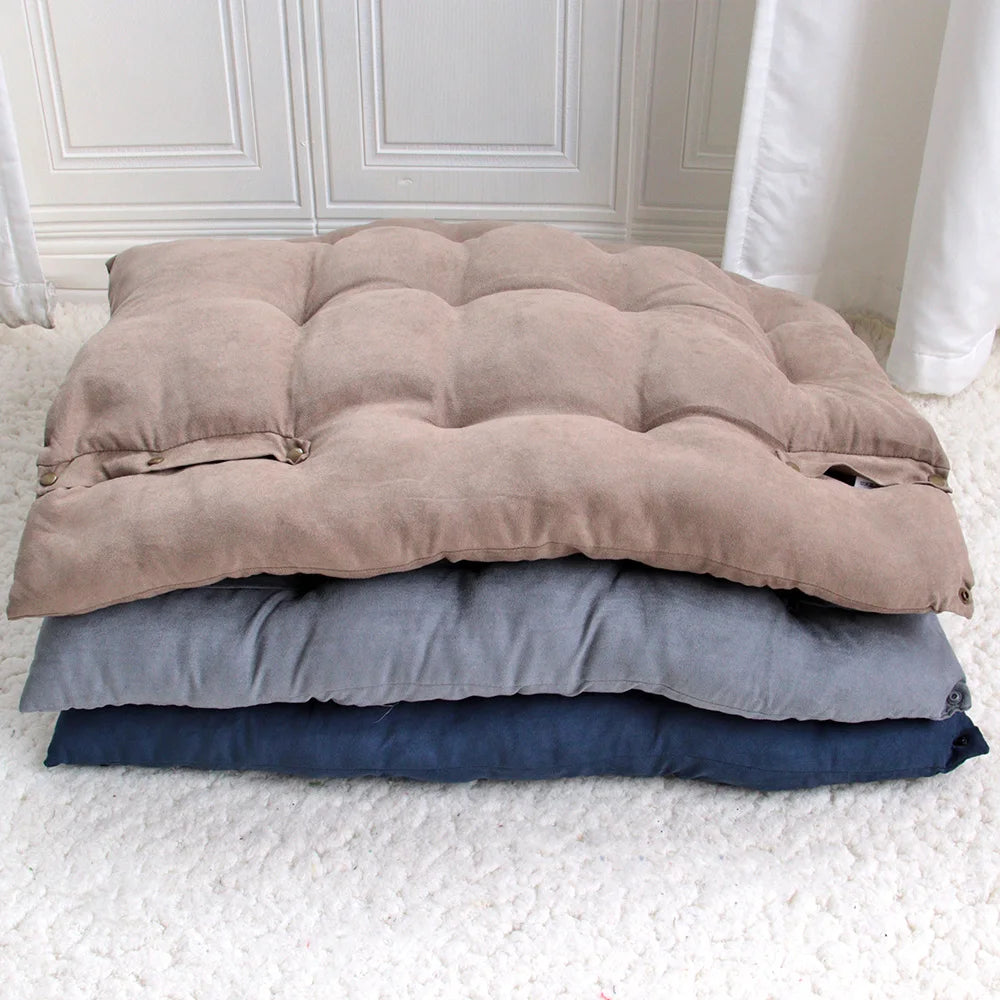 Three stacked foldable cushioned mats in beige, gray, and navy colors.