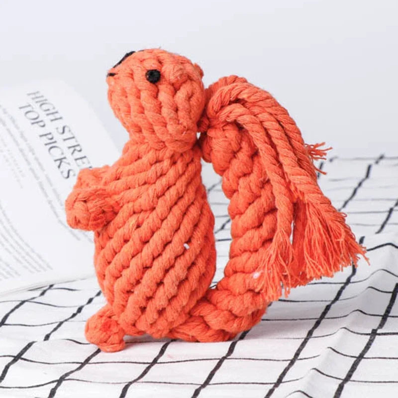 Orange rope toy shaped like a squirrel on a white surface