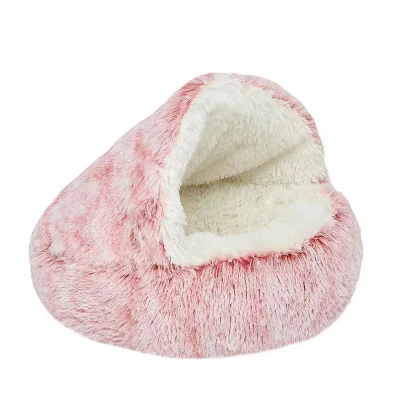 Pink and white fluffy pet bed on a white background