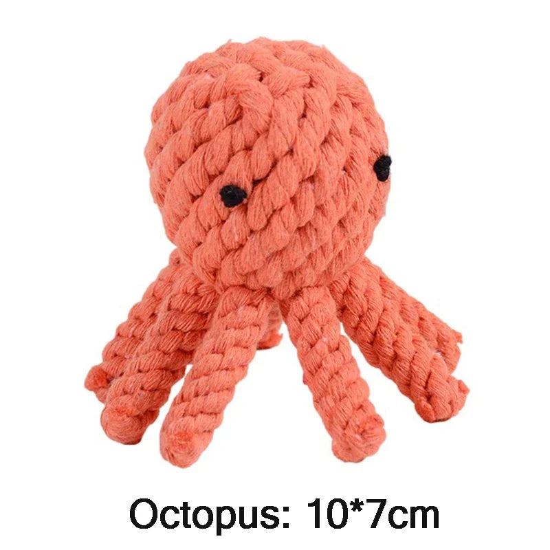 Coral-colored knitted octopus toy on a white background