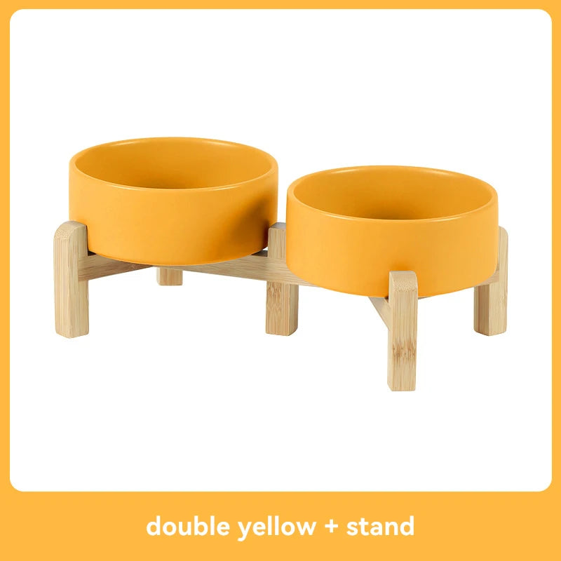 Double yellow pet feeder with wooden stand on a white background