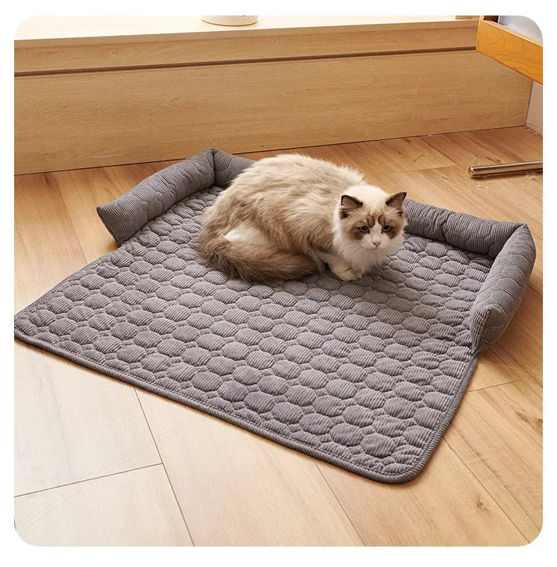 Cat lying on a textured gray mat on a wooden floor