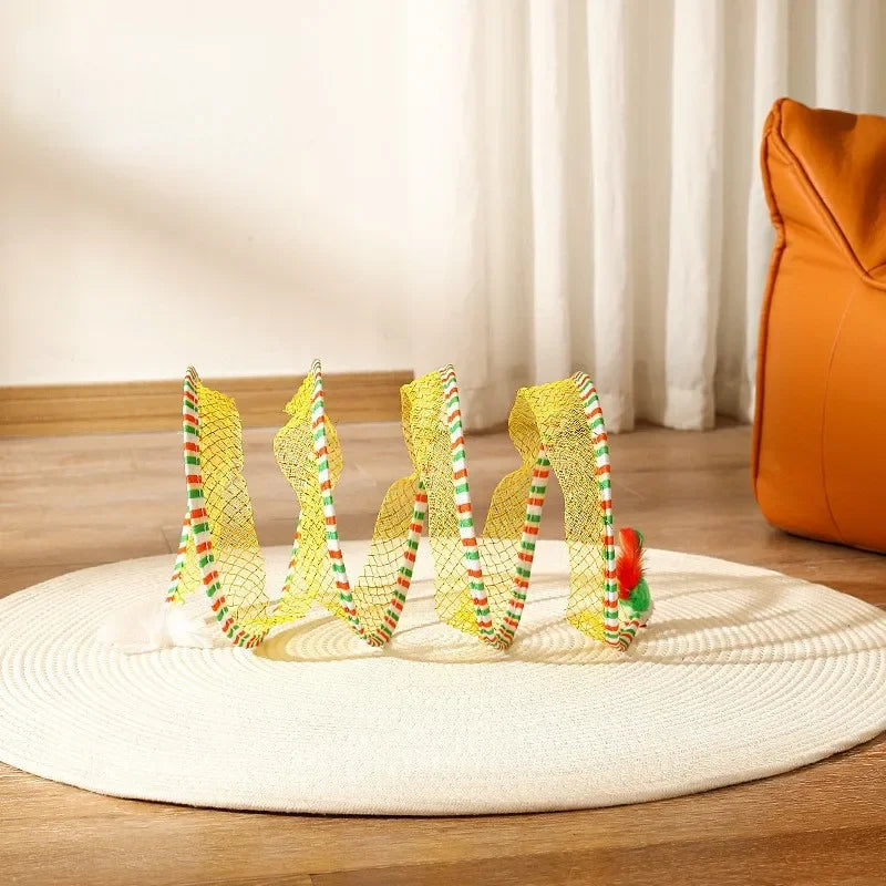 Colorful toy arch on a wooden floor with a white rug and orange chair in the background