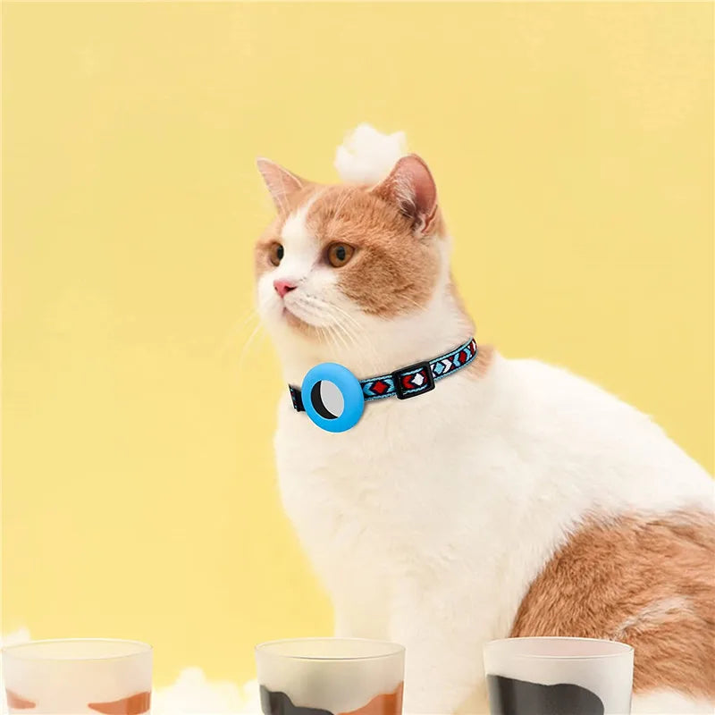 Cat wearing a colorful airtag collar on a yellow background