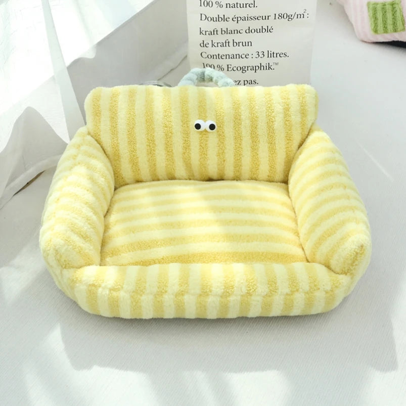 Yellow striped velvet pet bed with high sides for cats and small dogs.