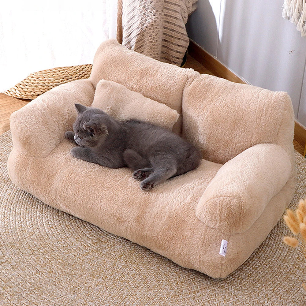 Cat curled up on plush sofa pet bed with soft bolstered backrest.