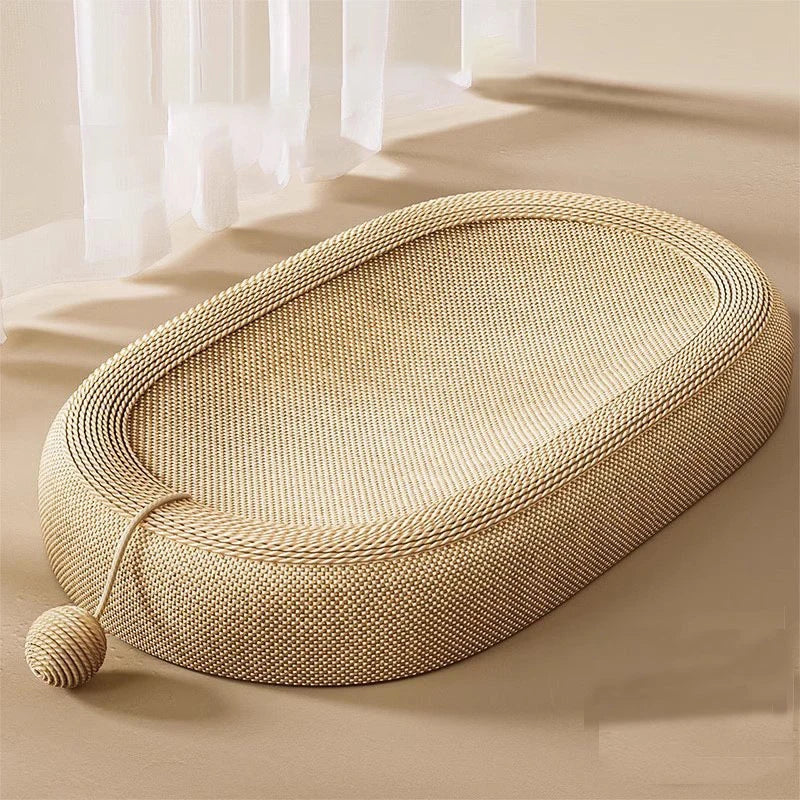 Beige sisal cat bed on a light wooden floor with sheer curtains in the background