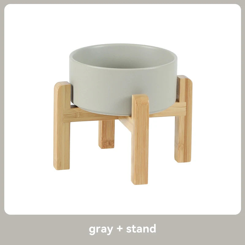 Gray ceramic pet feeder on a wooden stand 