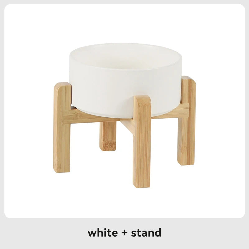 White ceramic pet bowl with wooden stand on a white background