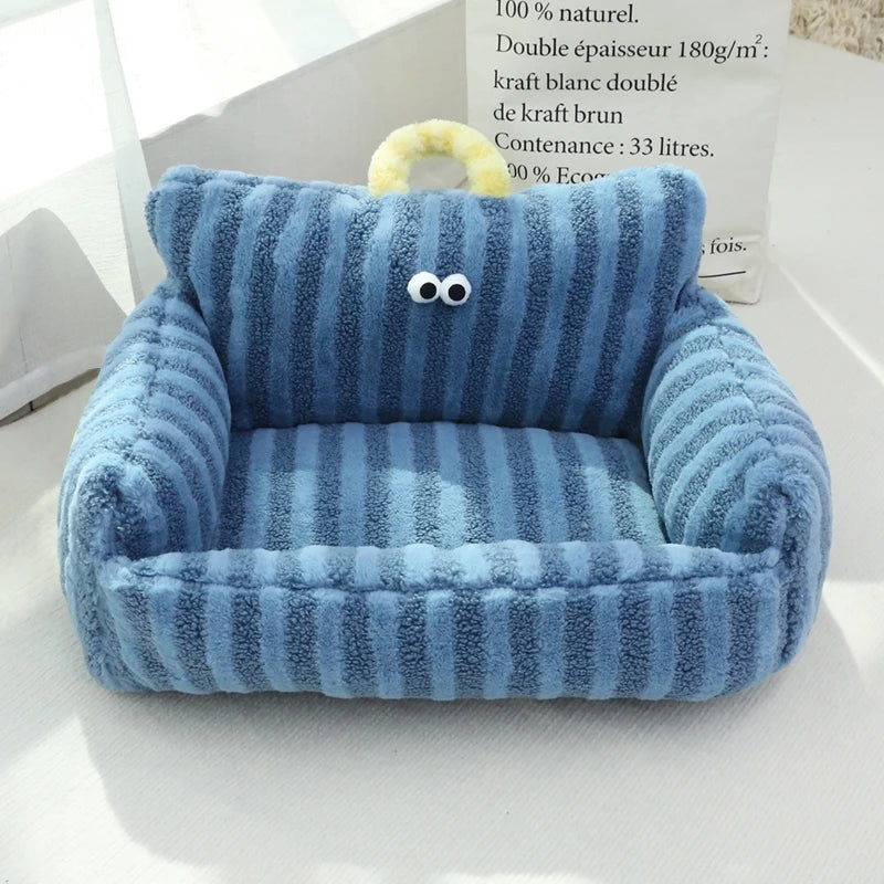 Blue striped velvet pet bed with cushioned nest design and googly eyes detail.