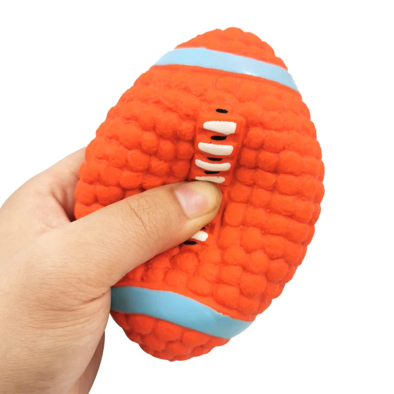 Hand holding an orange textured object with blue bands on a white background