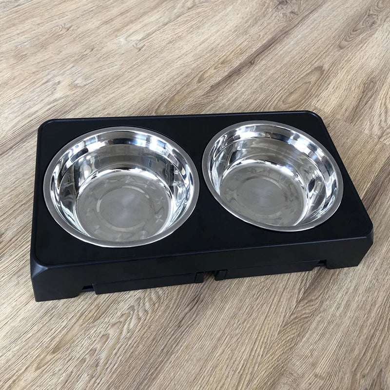 Pet food stainless steel bowl with black base on a wooden floor
