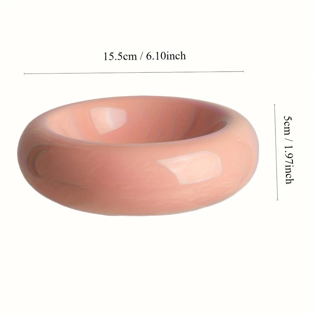 Ceramic bowl in pink with measurements on a white background