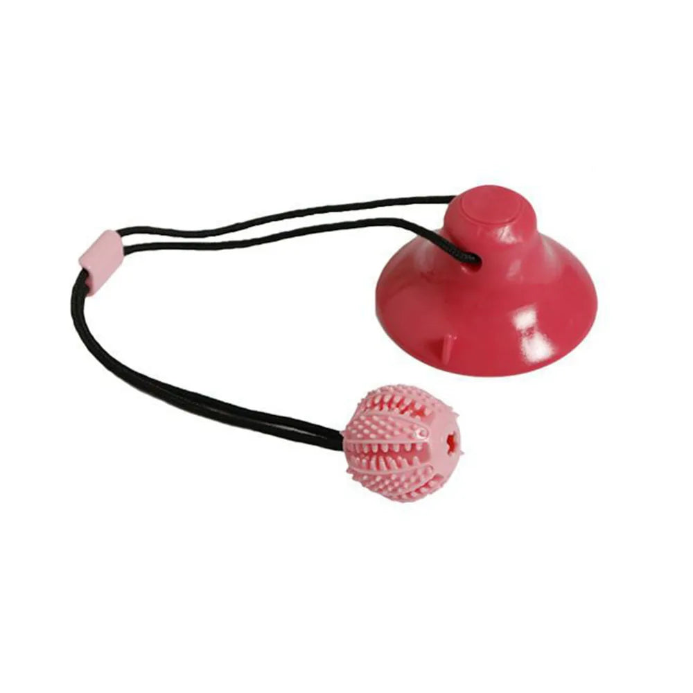Pink interactive pet toy with a suction cup and textured ball on a white background