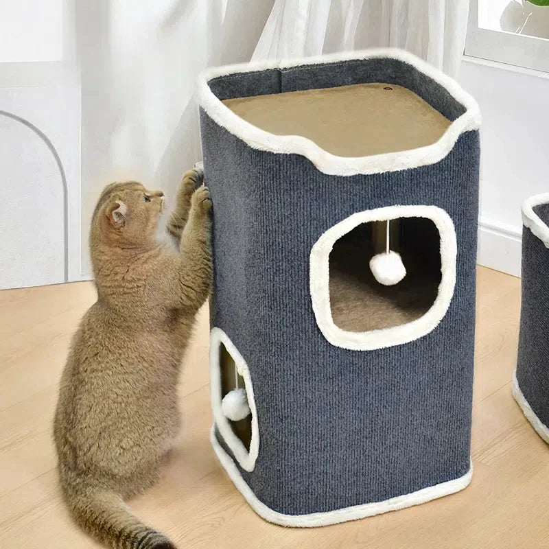 Cat playing with tower on a wooden floor.
