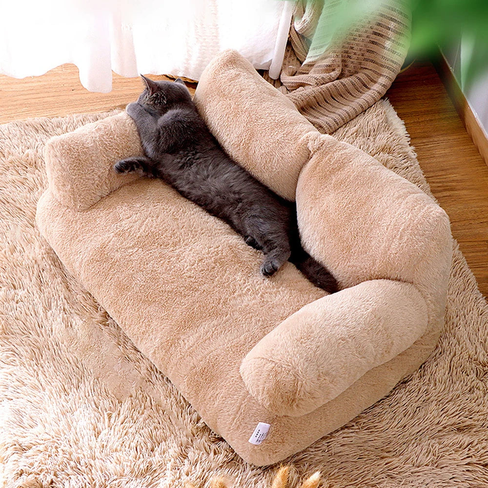 Cat stretching out comfortably on beige sofa-style pet bed.