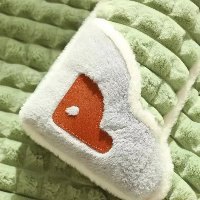 Close-up of green quilted plush dog bed with pillow detail.